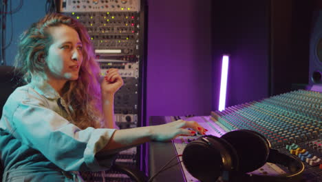 Portrait-of-Female-Sound-Engineer-at-Work-in-Recording-Studio